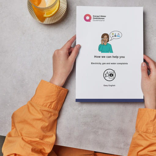 person holding a copy of easy english brochure